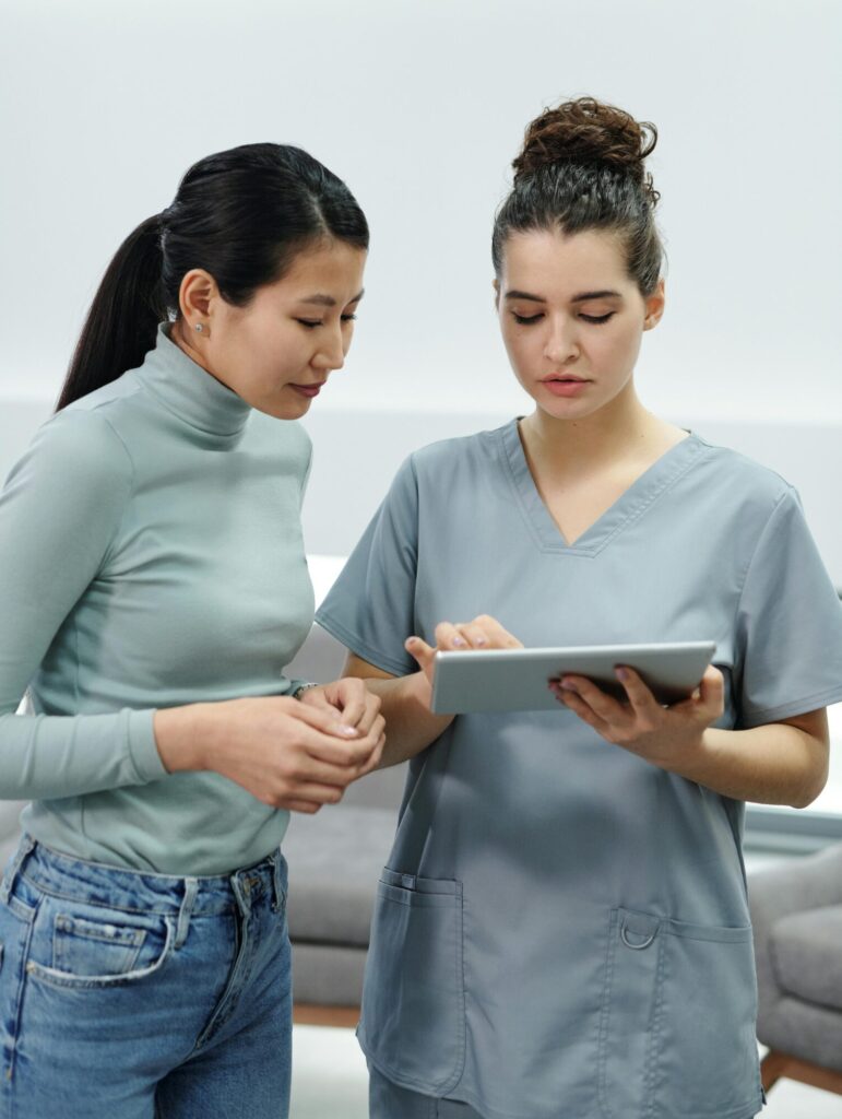 A doctor and a nurse coming together for an interdisciplinary care team meeting for a patient.