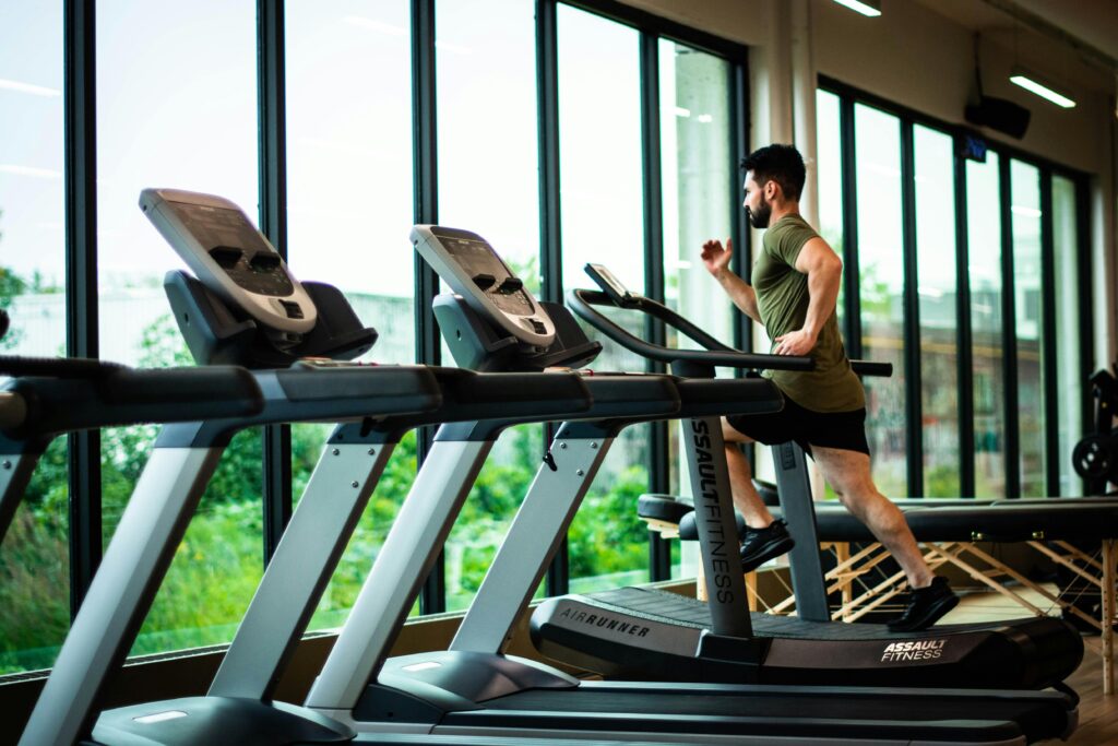 A man on a treadmill practicing preventive health.