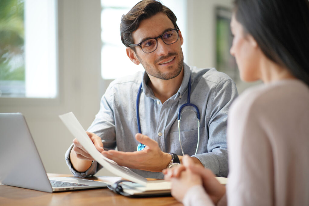 A doctor and a patient discussing Permanent Impairment Assessments.